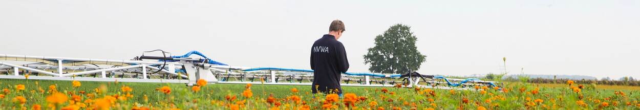 NVWA inspecteur controleert spuitmachine in bloemenveld